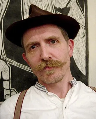 Billy Childish in front of one of his woodcuts